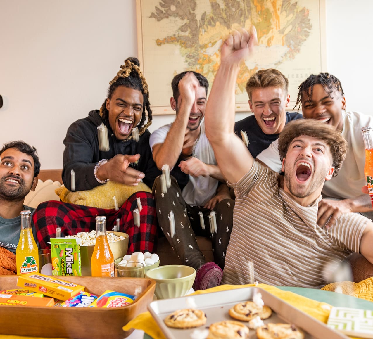 a group of friends laughing and enjoying snacks